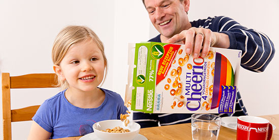 girl having breakfast with dad