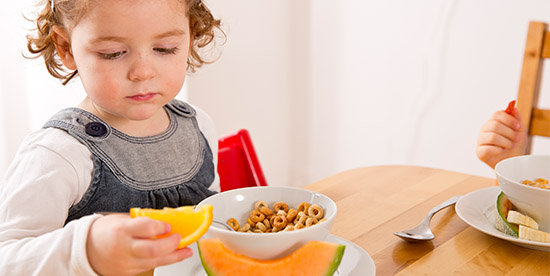 girl thinking whether to take another bite of food