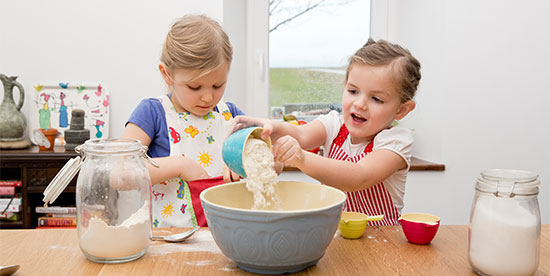 two girls baking in the kitchen