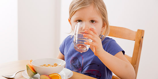 girl drinking a glass of water